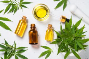 image of various CBD products with marijuana leaves in the background